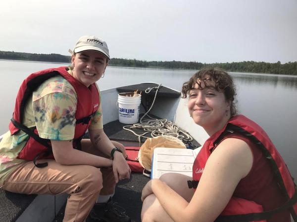 Biology students Cece Chmelik conducting research on a lake