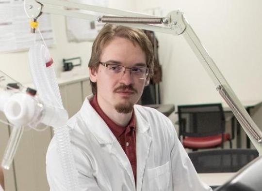 Exercise Science research study coordinator Owen Sloop in a white coat