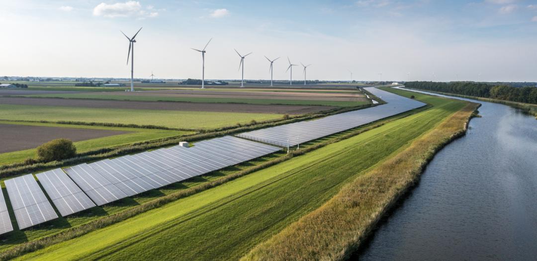 Wind turbines and solar panels illustrating alternative energy solutions (climate change stock)