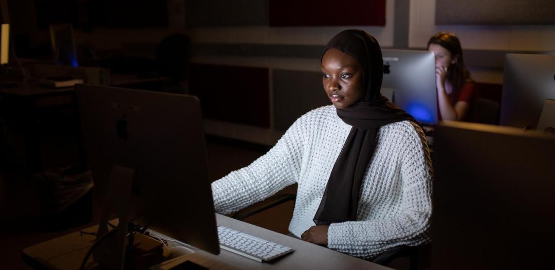 Student on computer in music studio